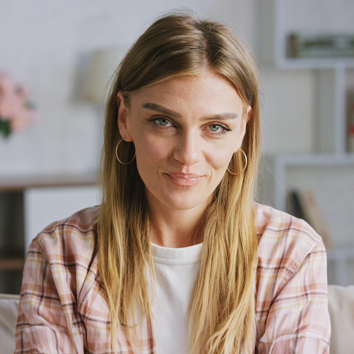 Portrait of smiling woman relaxing on sofa in