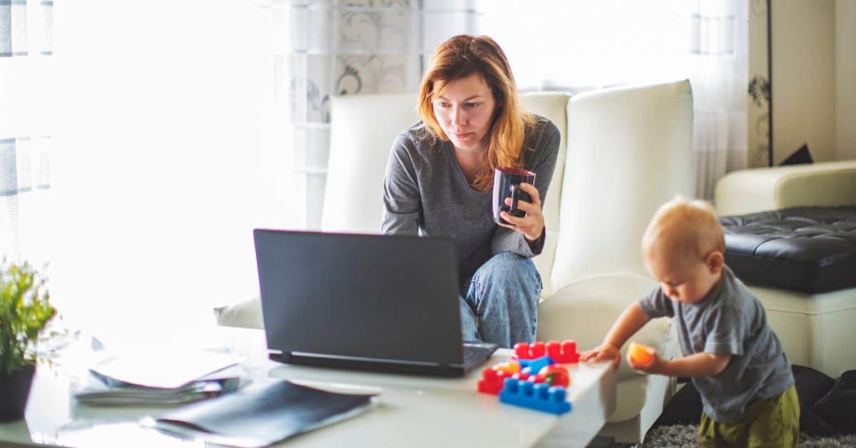 Mom working while parenting her toddler